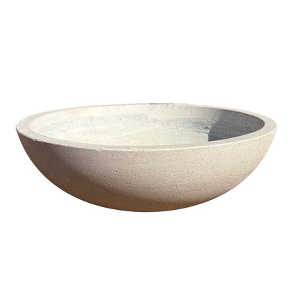 White low bowl fiberstone planter viewed from the front with a slight angle, emphasizing its low, rounded form and natural stone-look texture.