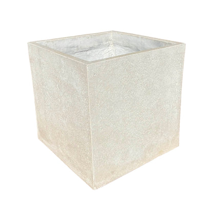 Grey cube fiberstone planter viewed from an angled corner, showing two sides of its balanced cube form and subtle stone texture.