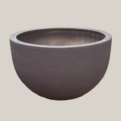 Brown large poly pot with wide rounded bowl shape and textured brown finish, slightly angled view highlighting its oversized form