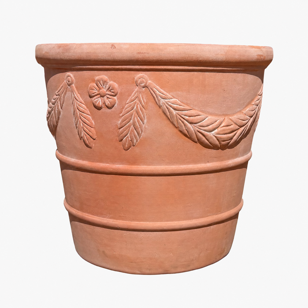 A terracotta clay pot with carved decorative leaf and garland motifs around the upper band, shown on a plain light gray background.