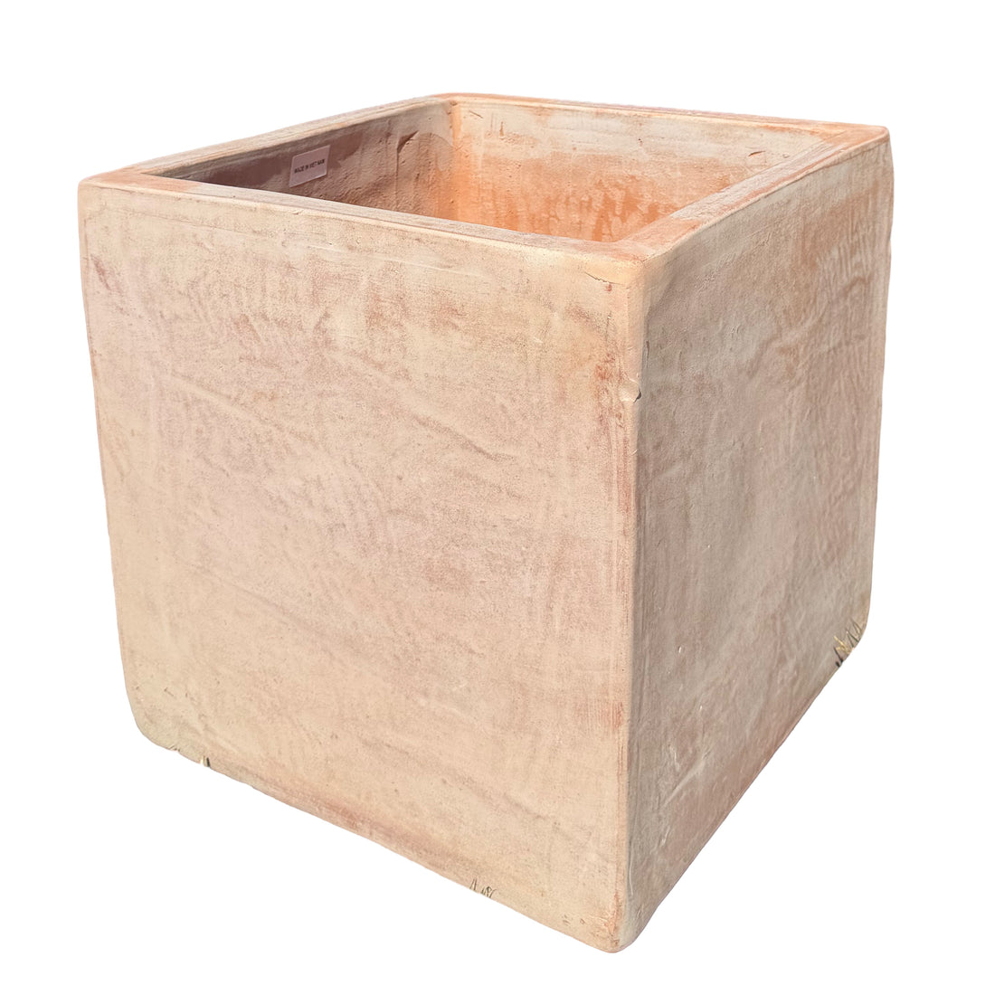 A square terracotta planter in a warm, textured beige-pink color, shown from a three-quarters perspective on a solid white background.