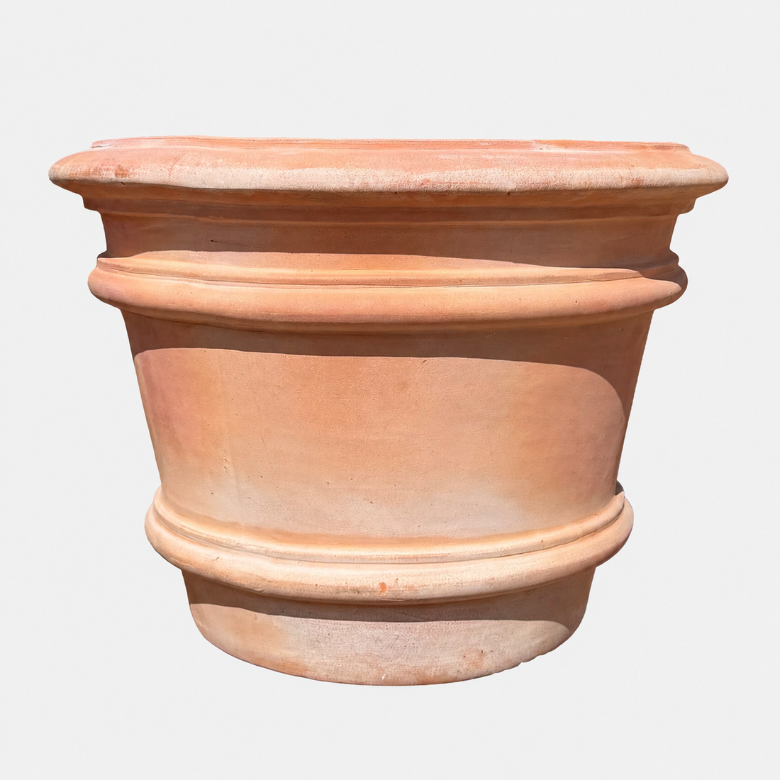 A terracotta planter pot with a classic warm orange-brown clay finish, featuring a flared rim and decorative horizontal bands, isolated on a light gray background.