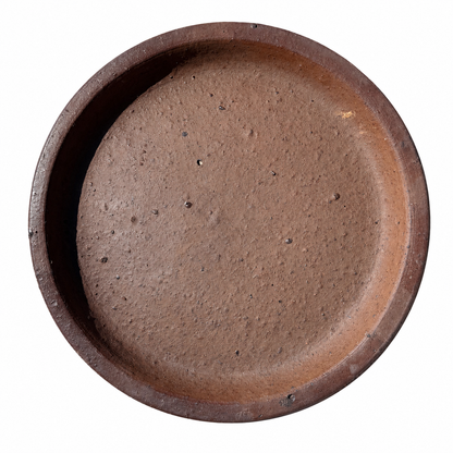 A round, shallow brown ceramic plant saucer with a textured, matte finish, shown from a top-down view on a solid white background.