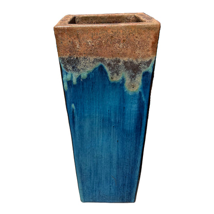 Tall square wedge planter seen from above, showing its open top and a textured bronze band melting into deep blue.