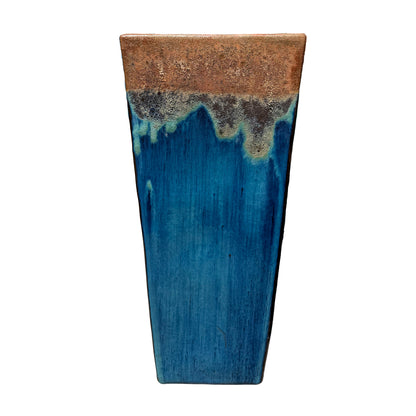 Front view of a two-tone tapered ceramic planter, with a speckled copper band over streaked turquoise and cobalt blue.