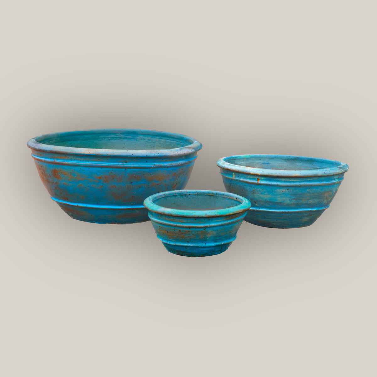 Three antique aqua low-bowl planters, slightly angled from above, with the large bowl left, the medium right, and the small in front.