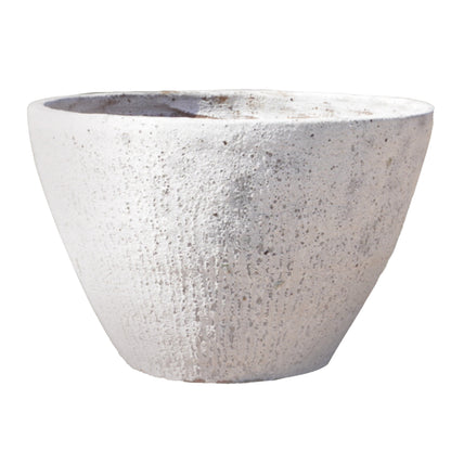 An Atlantis White Rustic Giant Cone Ceramic Planter tilted to reveal a hint of warm terracotta inside, its chalky white exterior streaked with soft grey mineral texture for an aged, sun-bleached look.