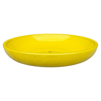 Angled view of a wide, shallow atomic yellow ceramic succulent bowl with a glossy bright-yellow interior, a rounded rim and a central drainage hole