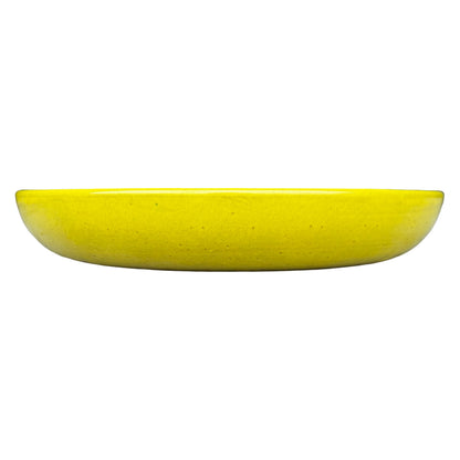 Side view of a shallow, rounded atomic yellow ceramic succulent bowl in a vivid sunny-yellow glaze with fine dark speckles