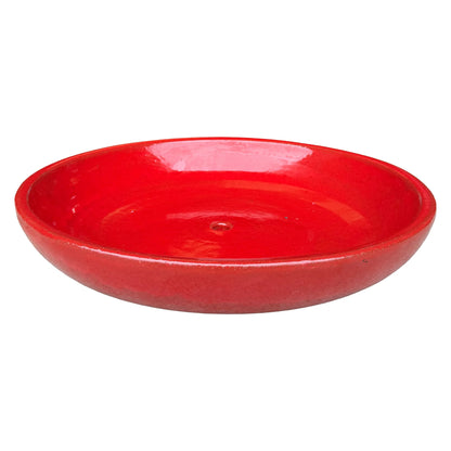 Angled view of a wide, shallow bright red ceramic succulent bowl with a vivid glossy interior, a rounded rim and a central drainage hole