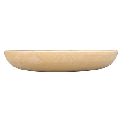 Eye-level front view of a shallow warm beige bird bath bowl, with a low rounded profile and a smooth, finely textured finish.