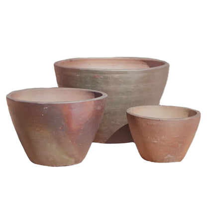 The Iron Clay Giant Cone Ceramic Planter in three sizes together, showing off that same earthy clay coloring and gently tapered cone shape from small to large-sized.