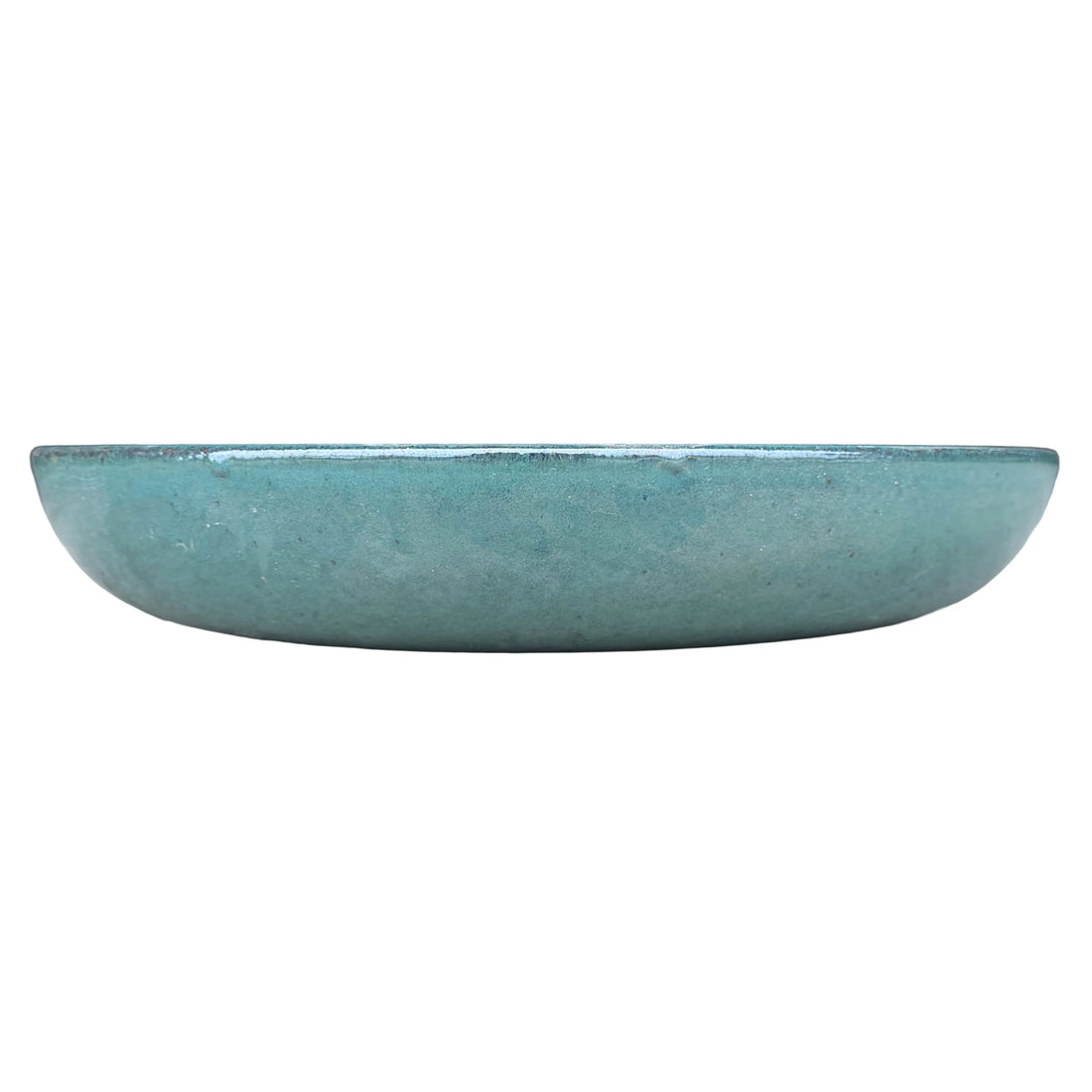 Eye-level front view of a jade ceramic succulent bowl, with a low, shallow profile and a glossy blue-green glaze with fine dark specks.