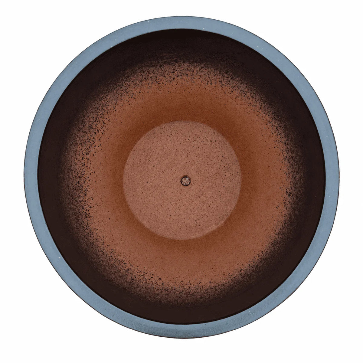 Top-down view of a matte black tapered round ceramic planter, with dark inner walls that fade into a terracotta interior with a raised circular centre and a small drainage hole