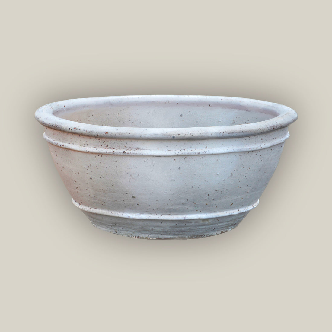 Matte White rustic low bowl ceramic planter, slightly angled from above to show its rolled rim, raised rings, and speckled finish.