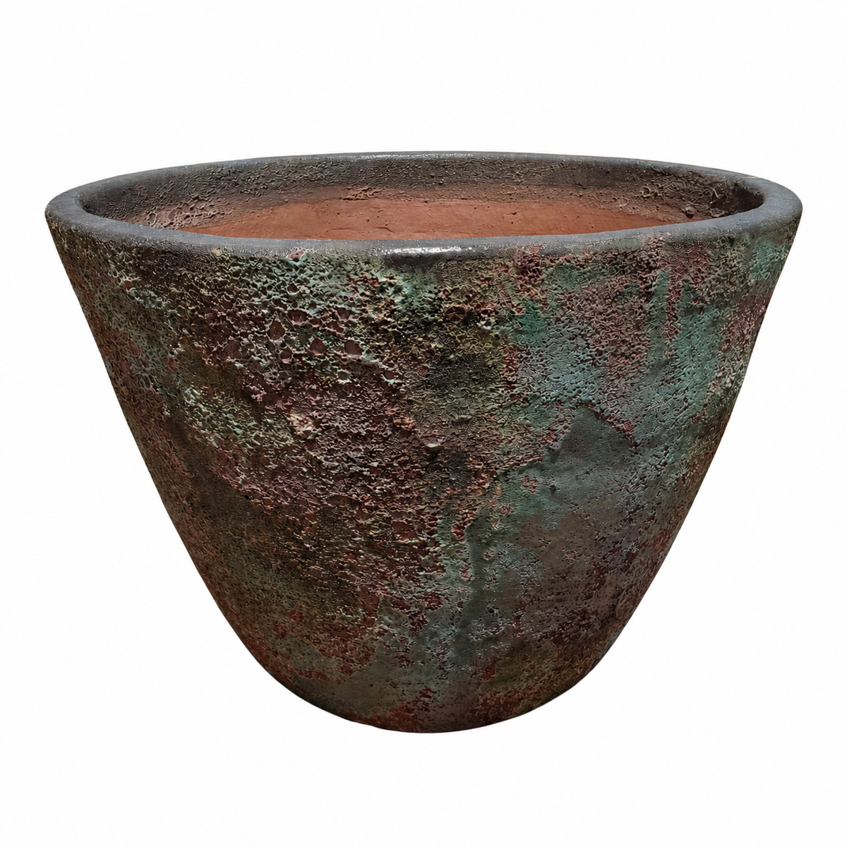 A Midnight Green Giant Cone Ceramic Planter tilted to reveal its warm terracotta interior, its exterior a striking mix of oxidized bronze, mossy green patina, and rust-red streaks like weathered copper.