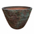 A Midnight Green Giant Cone Ceramic Planter tilted to reveal its warm terracotta interior, its exterior a striking mix of oxidized bronze, mossy green patina, and rust-red streaks like weathered copper.