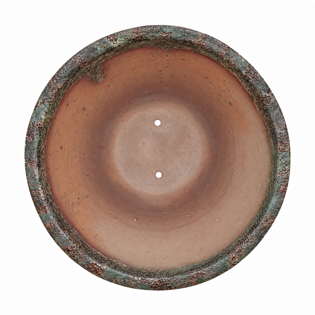 Looking straight down into the Midnight Green Giant Cone Ceramic Planter, its sun-warmed terracotta interior and drainage holes framed by a rugged rim streaked with green patina and rusty copper tones.