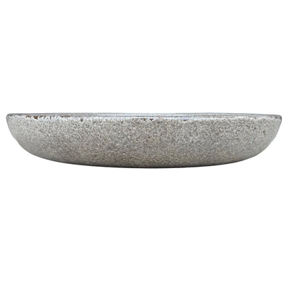 Front view of a shallow, rounded speckle black ceramic succulent bowl with a granite-like grey and white speckled glaze and a few rust-brown flecks along the rim