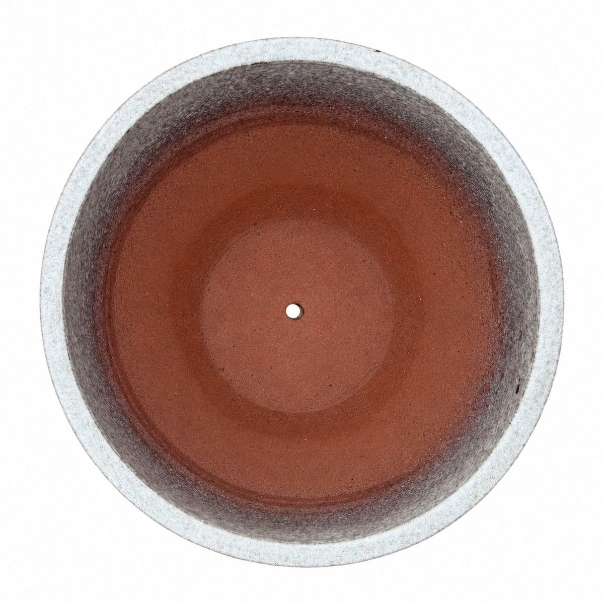 Top-down view of a speckle black tapered round ceramic planter, with a pale speckled rim and inner walls that shade from mottled grey into a terracotta-red floor with a small central drainage hole