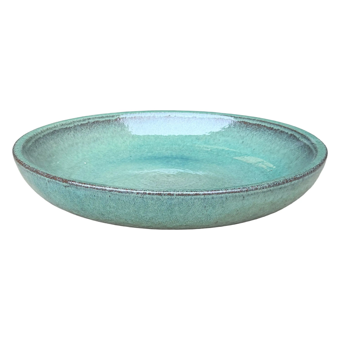 Teal ceramic bird bath bowl, slightly angled from above to show its shallow, glossy basin and brown-speckled rolled rim.