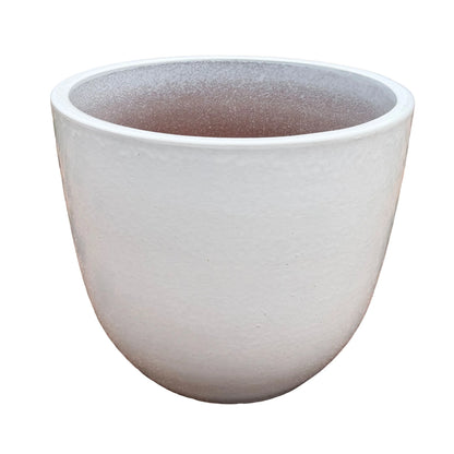 Angled view of a white tapered ceramic egg planter with a smooth rounded body, a soft satin glaze with subtle orange-peel texture, and a speckled interior that warms to terracotta