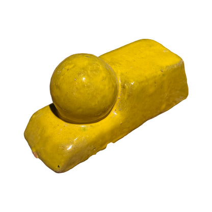 Yellow ceramic Bari pot feet at an angle, showing a glossy rectangular base topped with a rounded ball accent.