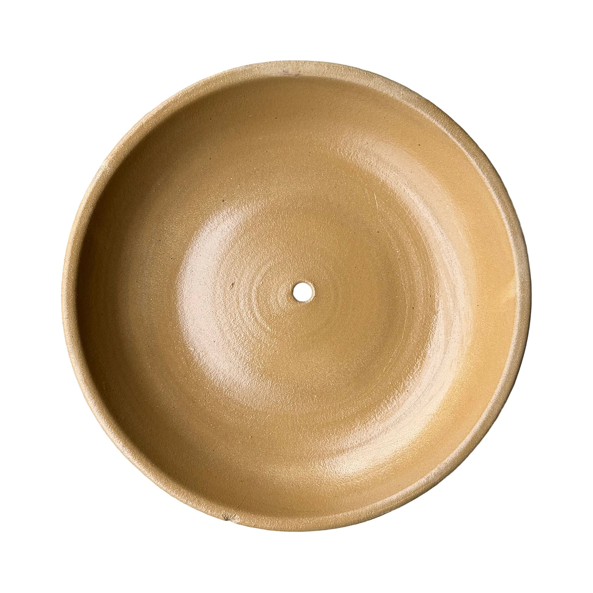 Underside of a yellow spray ceramic succulent bowl, where a matte sandy-yellow finish fades softly into a terracotta base with a central drainage hole